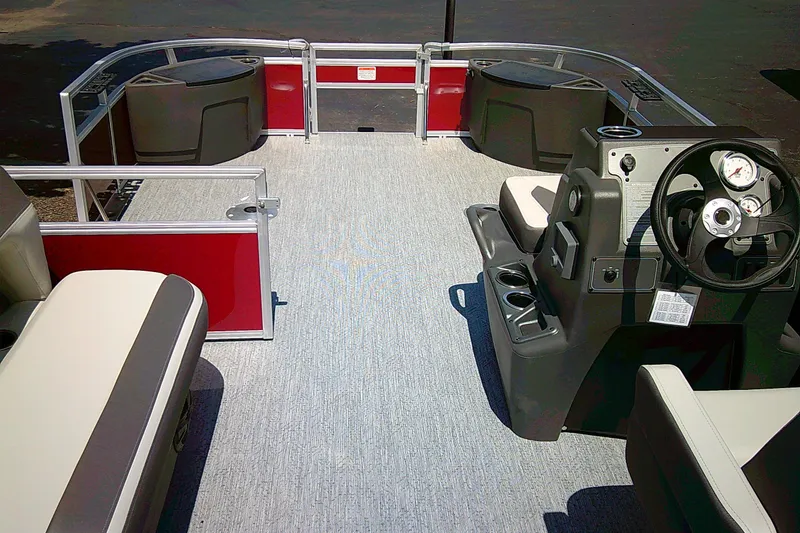 Slide: The Image of 2026 Sun Tracker Bass Buggy 18 DLX pontoon boat interior with steering console and seating. - 3