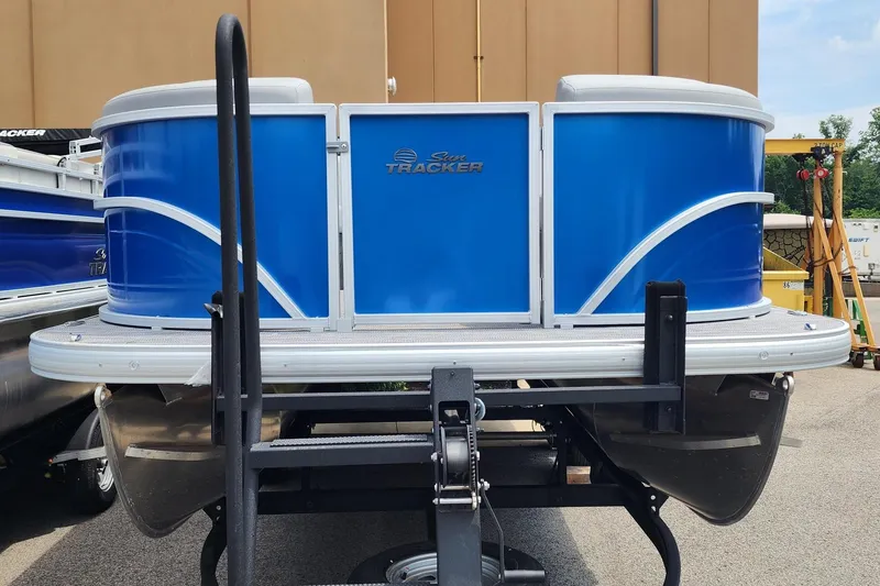 Slide: The Image of 2026 Sun Tracker Party Barge 20 DLX pontoon boat on trailer, front view. - 4