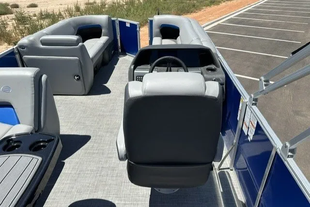 Slide: The Image of The image shows the cockpit of a 2026 Sun Tracker Party Barge 20 DLX with gray seating. - 14