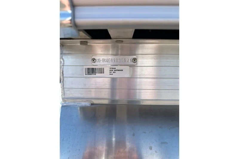 Slide: The Image of 2026 Sun Tracker Party Barge 20 DLX identification plate on aluminum surface. - 90