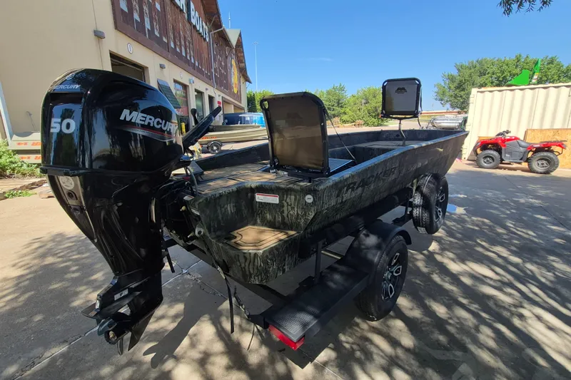 Slide: The Image of 2026 Tracker Grizzly 1650 T Prairie Wings Edition boat with Mercury 50 engine, parked outdoors. - 5