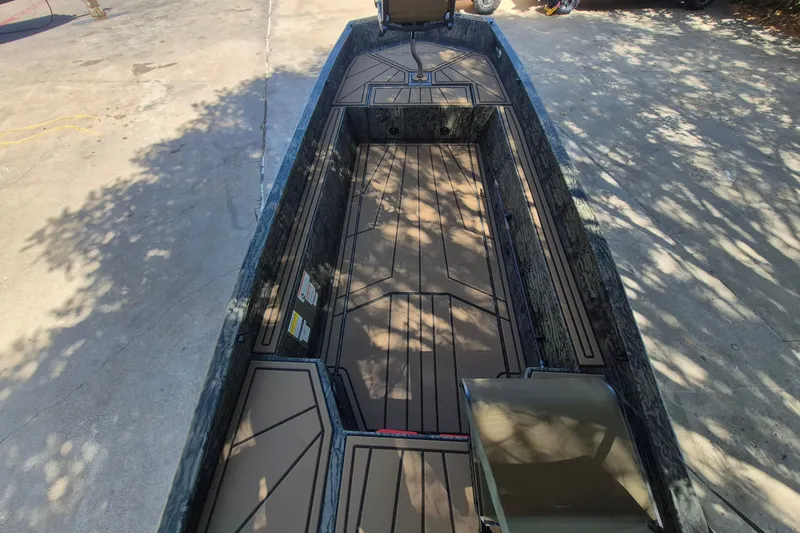 Slide: The Image of 2026 Tracker Grizzly 1650 T Prairie Wings Edition boat interior, featuring spacious deck and seating. - 8