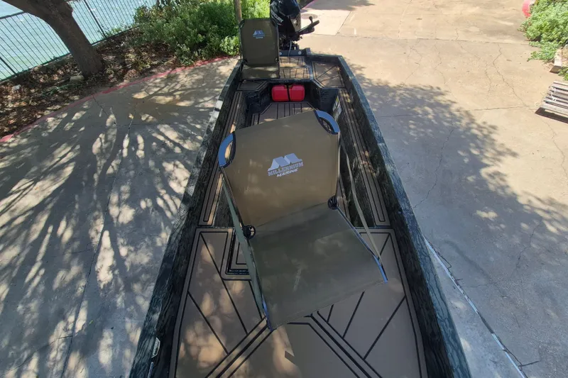 Slide: The Image of 2026 Tracker Grizzly 1650 T Prairie Wings Edition boat with seating and camouflage design. - 9