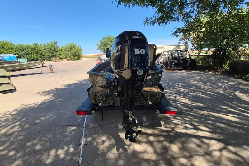 Slide: The Image of 2026 Tracker Grizzly 1650 T Prairie Wings Edition boat with Mercury 50 engine in outdoor setting. - 6