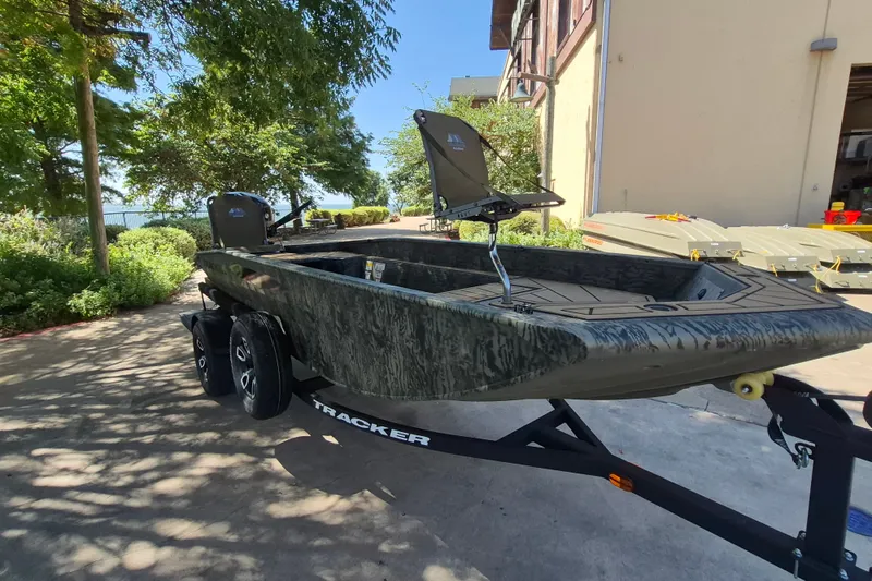 Slide: The Image of 2026 Tracker Grizzly 1650 T Prairie Wings Edition boat on trailer, outdoors in sunlight. - 3