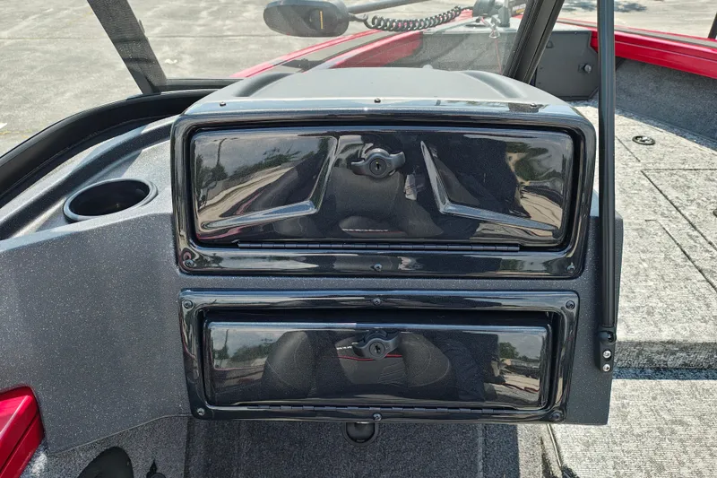 Slide: The Image of 2026 Tracker Targa V-19 WT boat dashboard with storage compartments and cup holder. - 10