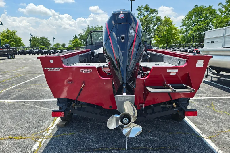 Slide: The Image of 2026 Tracker Targa V-19 WT boat with powerful outboard motor in a parking lot. - 19