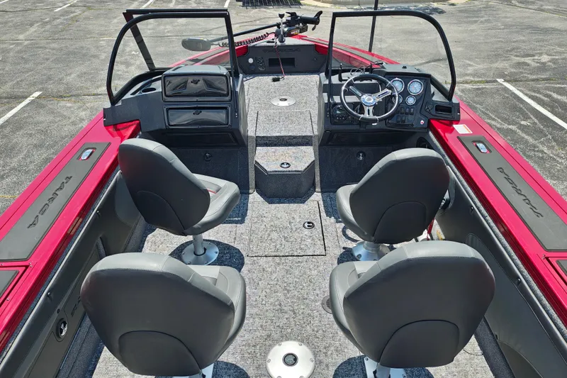 Slide: The Image of 2026 Tracker Targa V-19 WT boat interior with four seats and steering console. - 5