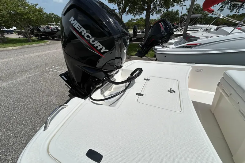 Slide: The Image of 2026 Mako Pro Skiff 17 CC with Mercury outboard motor in a marina setting. - 6