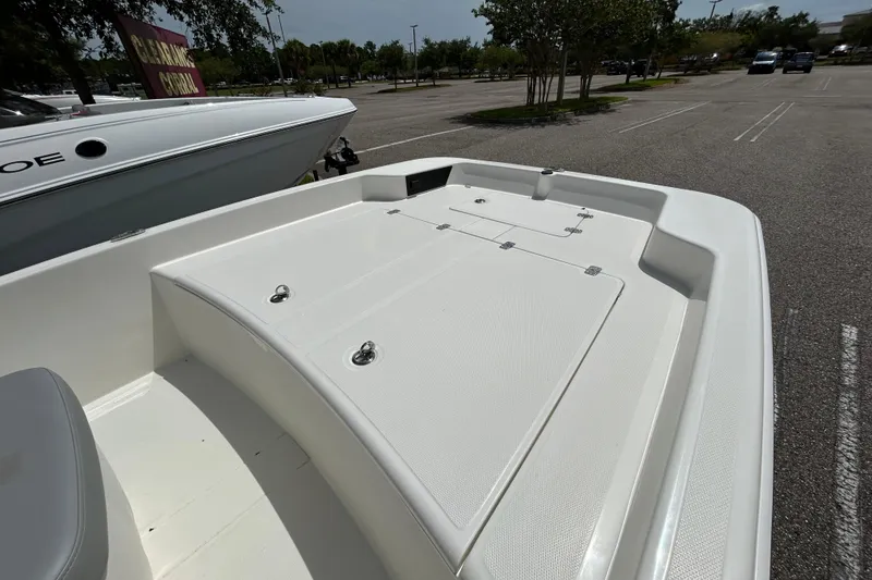 Slide: The Image of 2026 Mako Pro Skiff 17 CC boat deck in a parking lot, showcasing storage compartments. - 3