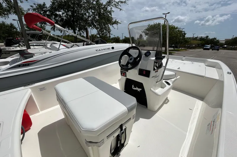 Slide: The Image of 2026 Mako Pro Skiff 17 CC boat interior with steering console and seating. - 5