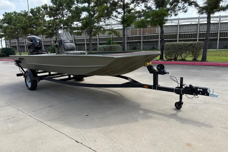 Slide: The Image of 2026 Tracker Grizzly 1860 CC boat on trailer, parked outdoors. - 2