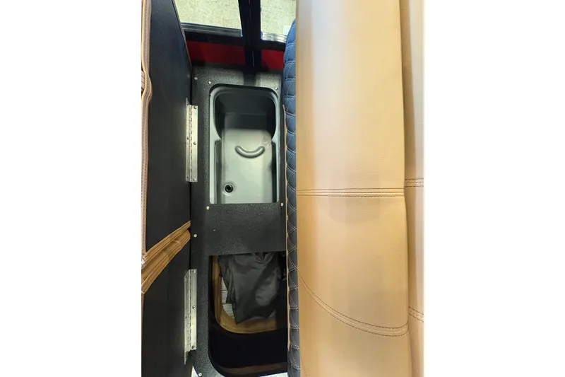 Slide: The Image of Interior view of 2026 Ranger 223FC, featuring tan and black seating with storage compartment. - 10