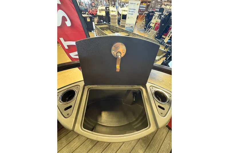 Slide: The Image of Open storage compartment on 2026 Ranger 223FC boat, featuring cup holders and a sleek design. - 22