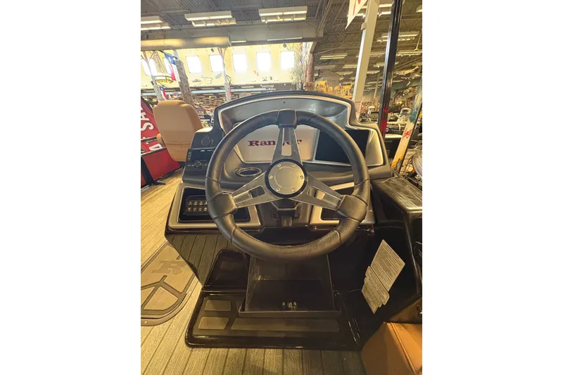 Slide: The Image of Steering wheel of 2026 Ranger 223FC boat in showroom setting. - 16