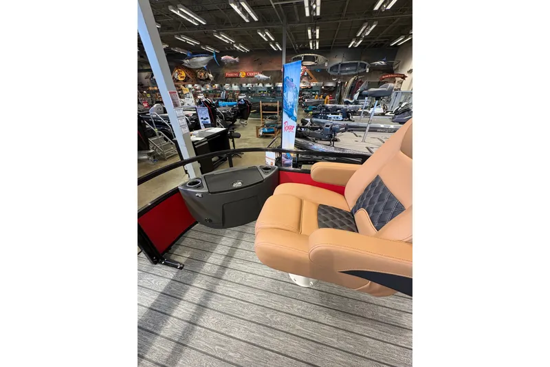 Slide: The Image of 2026 Ranger 223FC boat interior with tan seating and fishing gear display. - 20