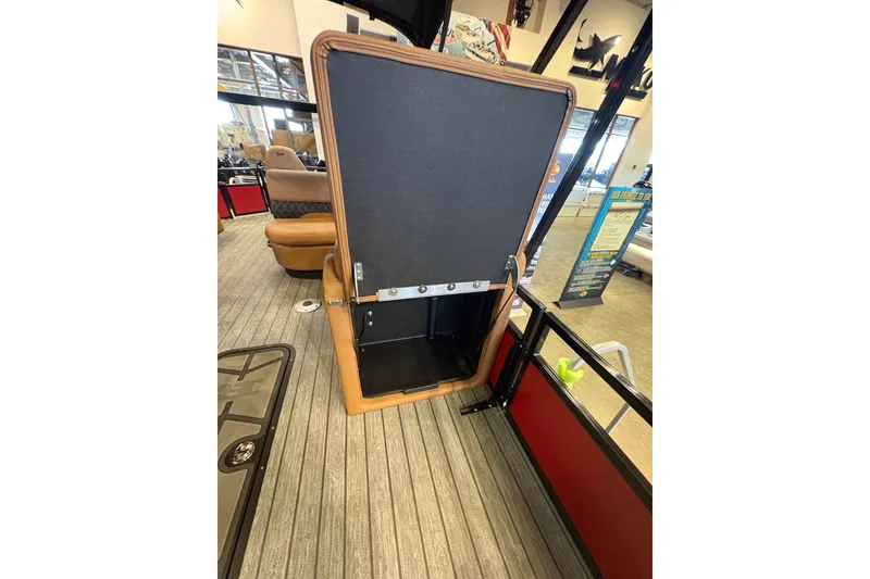 Slide: The Image of Open storage compartment on 2026 Ranger 223FC boat, showcasing interior space and seating area. - 13