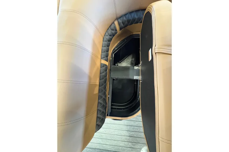 Slide: The Image of Interior view of 2026 Ranger 223FC boat, featuring tan and black seating with storage compartment. - 12