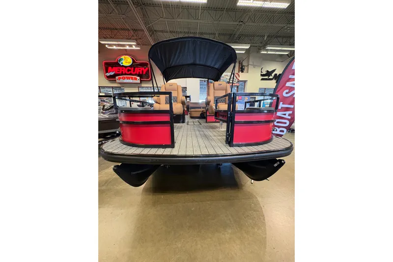 Slide: The Image of 2026 Ranger 223FC pontoon boat with red accents displayed indoors. - 1