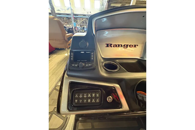 Slide: The Image of 2026 Ranger 223FC boat dashboard with control panel and cup holder. - 18
