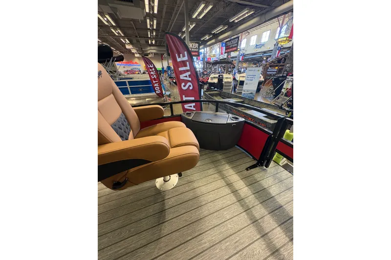 Slide: The Image of 2026 Ranger 223FC boat interior at a showroom with sale banners. - 21