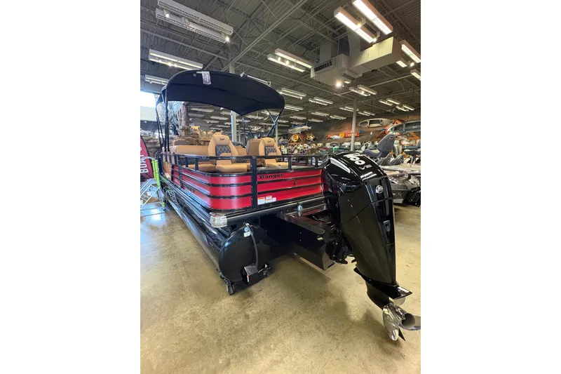 Slide: The Image of 2026 Ranger 223FC pontoon boat with red and black design, displayed indoors. - 5