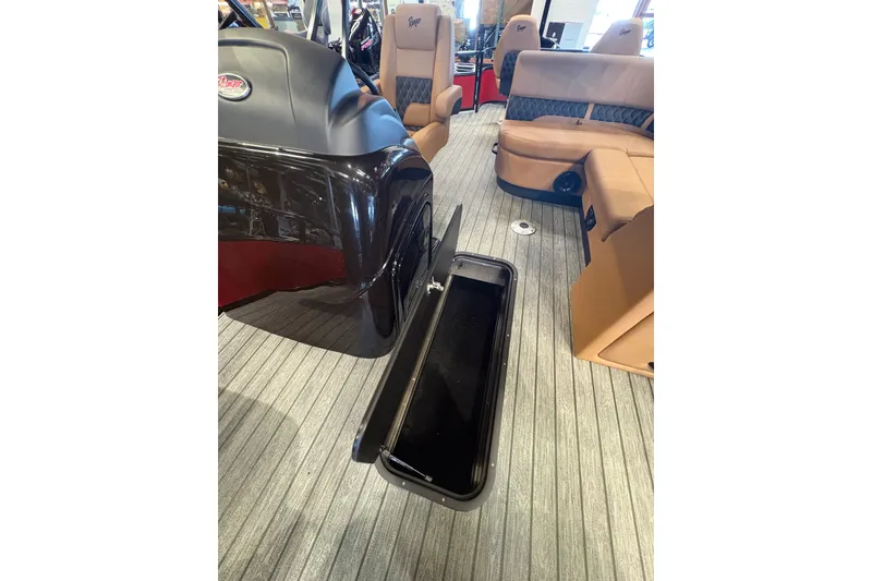 Slide: The Image of 2026 Ranger 223FC boat interior with tan seating and open storage compartment. - 14