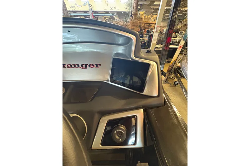 Slide: The Image of 2026 Ranger 223FC boat dashboard with modern controls and display screen. - 19