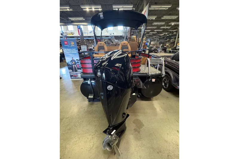 Slide: The Image of 2026 Ranger 223FC boat with powerful outboard motor displayed indoors. - 4