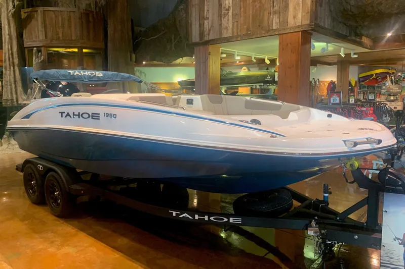 The Image of 2026 Tahoe 1950 boat displayed indoors on a trailer, showcasing sleek design and modern features. - 0