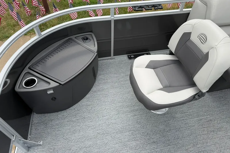 Slide: The Image of 2026 Sun Tracker Fishin' Barge 22 XP3 interior with seating and storage compartment. - 13
