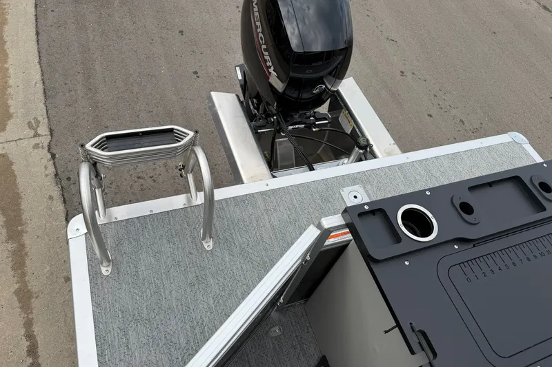 Slide: The Image of 2026 Sun Tracker Fishin' Barge 22 XP3 with Mercury engine, featuring a fishing station and ladder. - 23