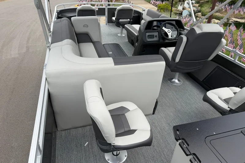 Slide: The Image of 2026 Sun Tracker Fishin' Barge 22 XP3 interior with plush seating and modern helm. - 24
