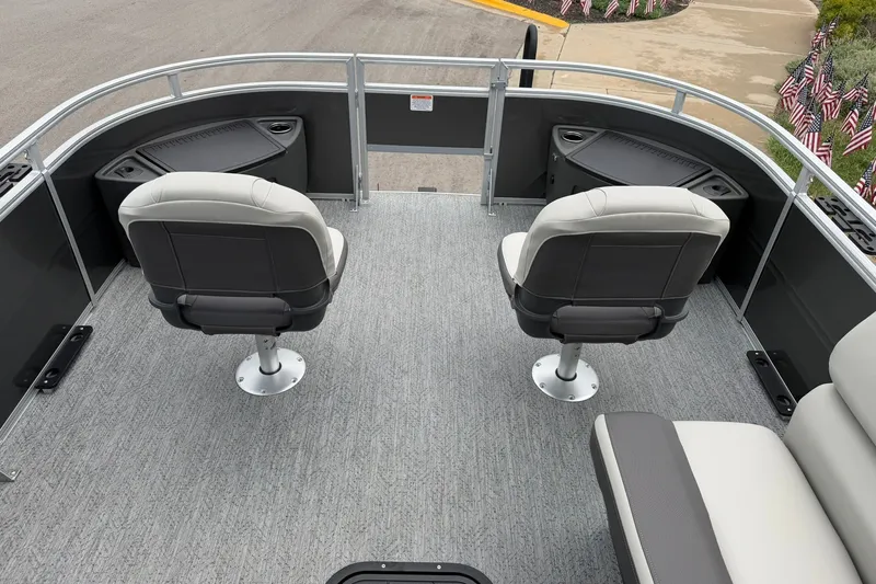 Slide: The Image of 2026 Sun Tracker Fishin' Barge 22 XP3 interior with two swivel seats and gray flooring. - 14