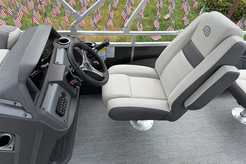 Slide: The Image of 2026 Sun Tracker Fishin' Barge 22 XP3 interior with captain's chair and control panel. - 18