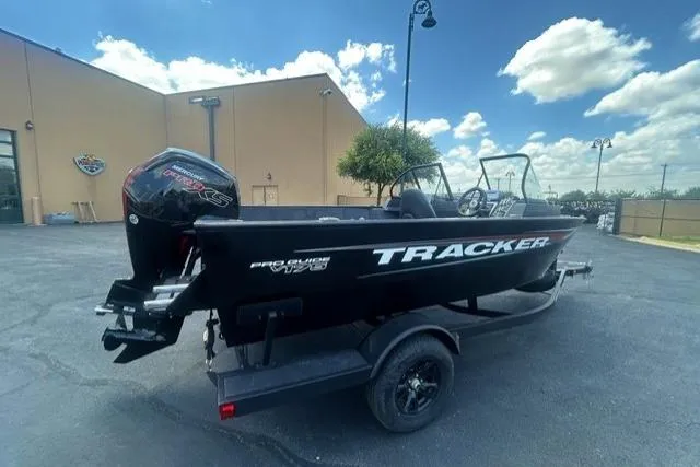 Slide: The Image of 2026 Tracker Pro Guide V-175 Combo boat on trailer, parked outdoors under a cloudy sky. - 3