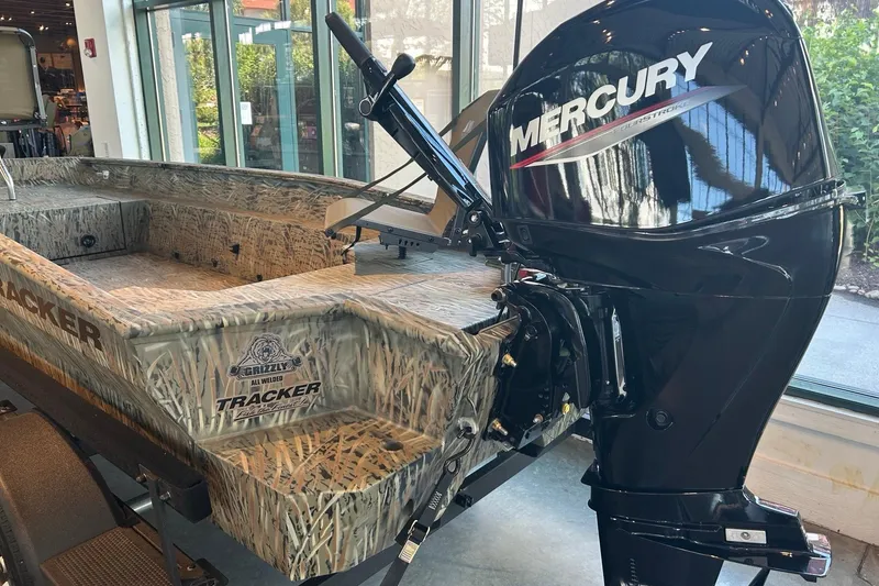Slide: The Image of 2026 Tracker Grizzly 1650 T Prairie Wings Edition boat with Mercury engine in showroom. - 3