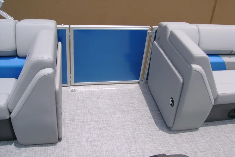 Slide: The Image of 2026 Sun Tracker Party Barge 20 DLX interior seating with blue and gray upholstery. - 11