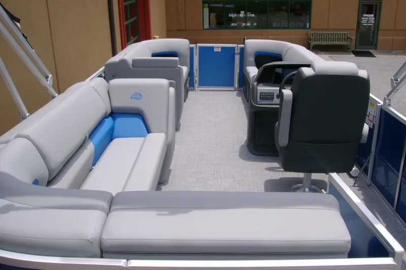 Slide: The Image of 2026 Sun Tracker Party Barge 20 DLX interior with spacious seating and modern helm. - 13