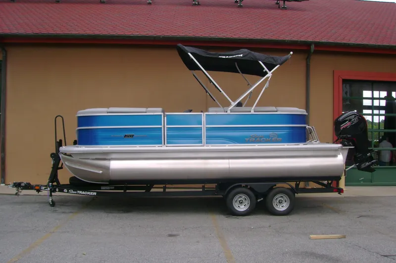 Slide: The Image of 2026 Sun Tracker Party Barge 20 DLX pontoon boat on trailer, blue exterior. - 87