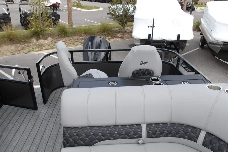 Slide: The Image of 2026 Ranger 223FC boat interior with gray seating and cup holders. - 19