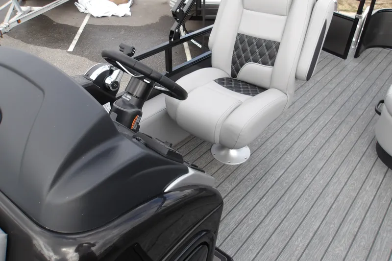 Slide: The Image of 2026 Ranger 223FC boat interior with sleek steering console and cushioned seating. - 27
