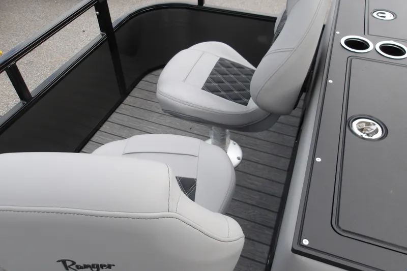 Slide: The Image of 2026 Ranger 223FC boat interior with gray cushioned seats and sleek design. - 21