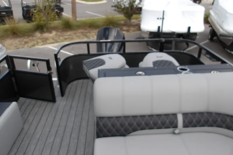 Slide: The Image of 2026 Ranger 223FC boat interior with gray seating and open gate. - 18