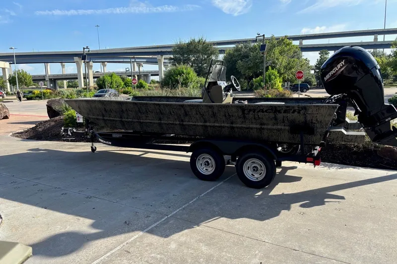 The Image of 2026 Tracker Grizzly 2072 CC boat on trailer, parked outdoors under clear sky. - 0