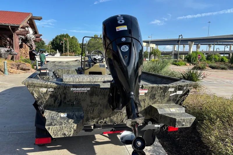 Slide: The Image of 2026 Tracker Grizzly 2072 CC boat with powerful outboard motor, parked outdoors. - 15