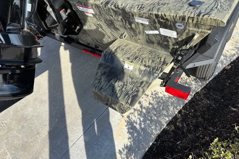 Slide: The Image of 2026 Tracker Grizzly 2072 CC boat trailer with camouflage design and red reflectors. - 7