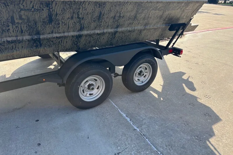 Slide: The Image of Trailer with Tracker Grizzly 2072 CC boat, 2026 model, parked on concrete surface. - 11