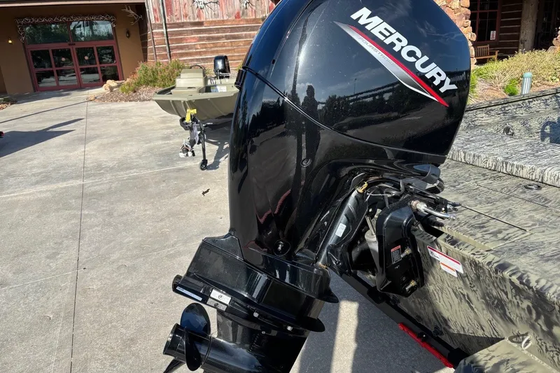 Slide: The Image of 2026 Tracker Grizzly 2072 CC with Mercury outboard motor in driveway. - 14