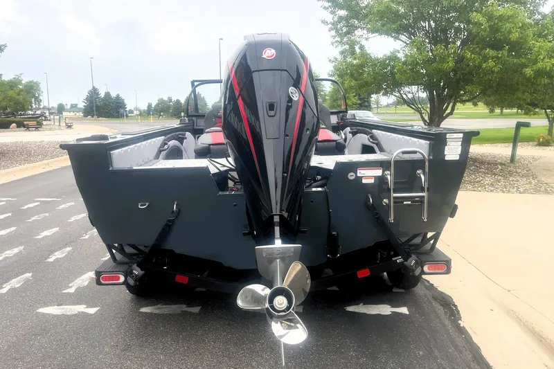 Slide: The Image of 2026 Ranger VX1988 WT boat with powerful outboard motor, parked on a paved area. - 5